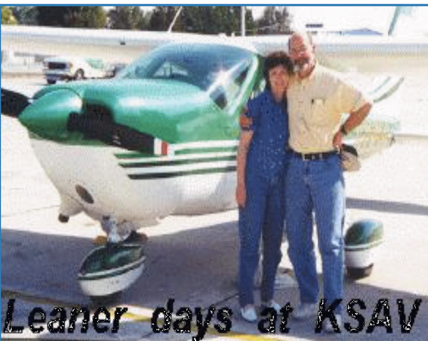 A couple stands smiling beside a green and white airplane at KSAV airport, evoking nostalgia for their earlier flying days.